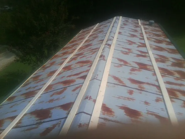 Rusted metal roof panels with new wood purlins before replacement — Storm Damage Roof Repair in Tobyhanna by Roofing Brothers